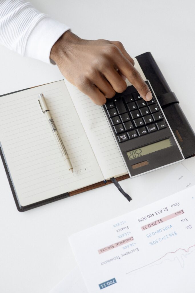 Person reviewing TMS therapy cost and insurance paperwork with a calculator in Miami