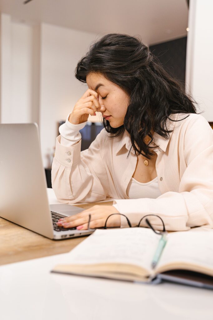 Adult struggling to focus at a desk representing adult ADHD treatment in Miami