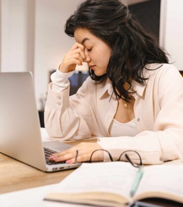 Adult struggling to focus at a desk representing adult ADHD treatment in Miami