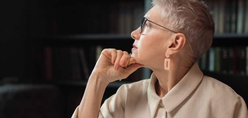 Woman reflecting, representing menopause and mental health care in Miami