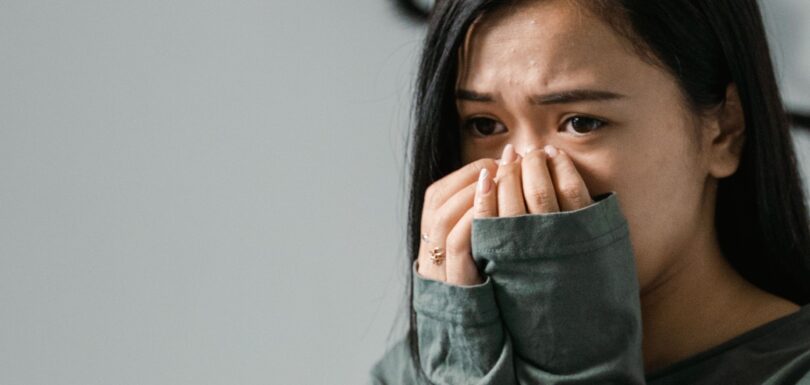 Person weighing therapy versus medication for mental health in Miami