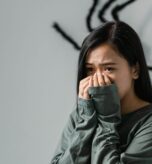 Person weighing therapy versus medication for mental health in Miami